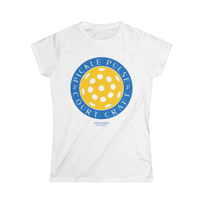 A white women's t-shirt with a round graphic design in the center that features text and a pickleball pattern.