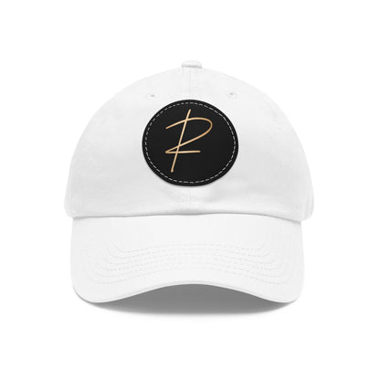 A white, unstructured, six-panel low-profile pickleball hat with a leather patch on the front featuring the letter 'R' in a darker color.